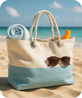 A large, relaxed beach tote bag in cream and light blue tones with rope handles